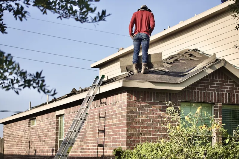 Professional roofer working on a residential roof in North Brookfield
